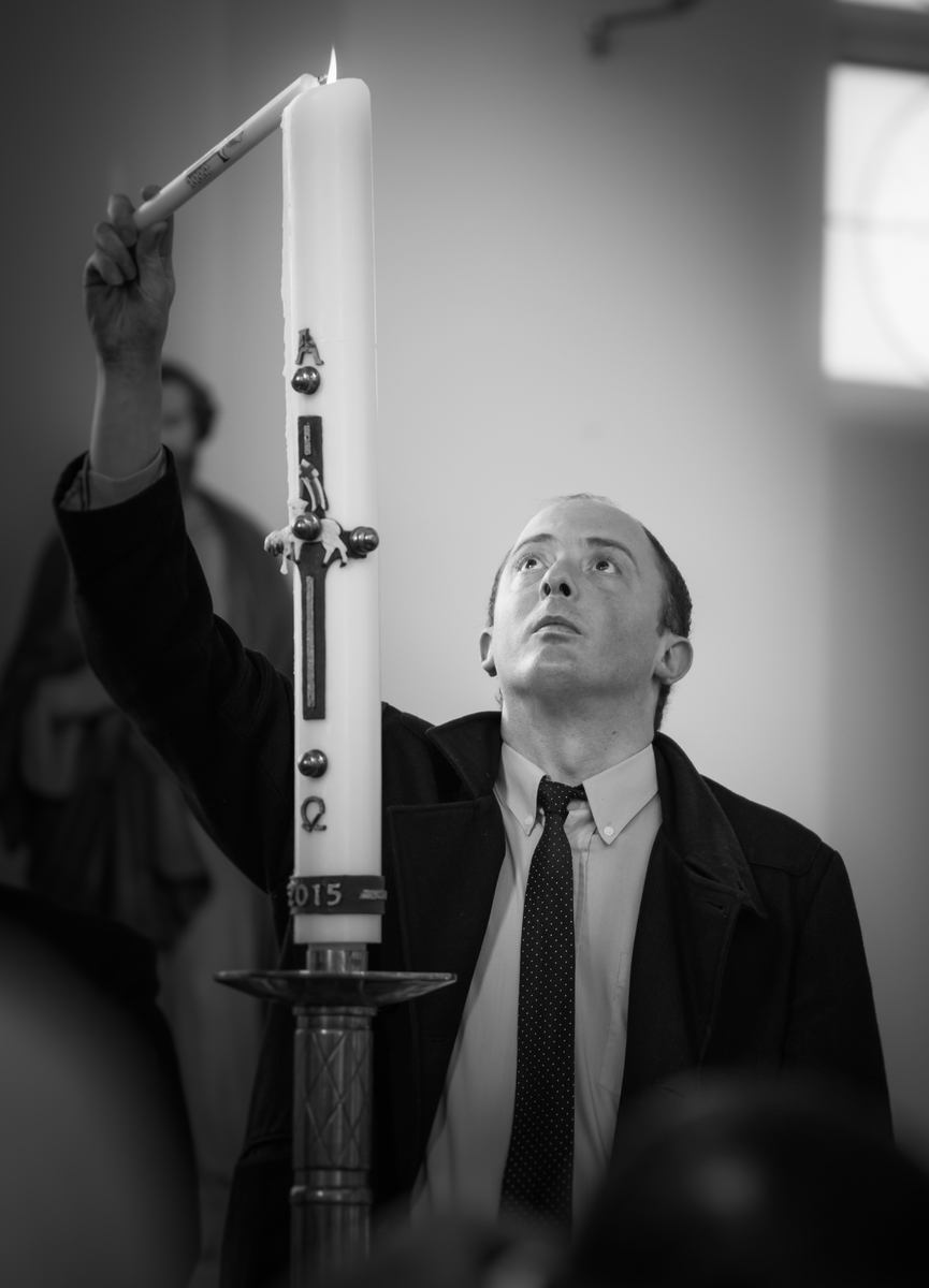 Jo Newbury Photography portrait portrait man lighting candle in church