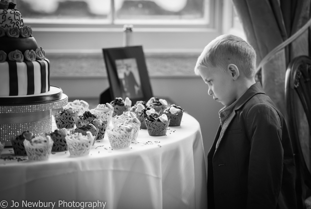 Jo Newbury Photography wedding boy looking at cupcakes