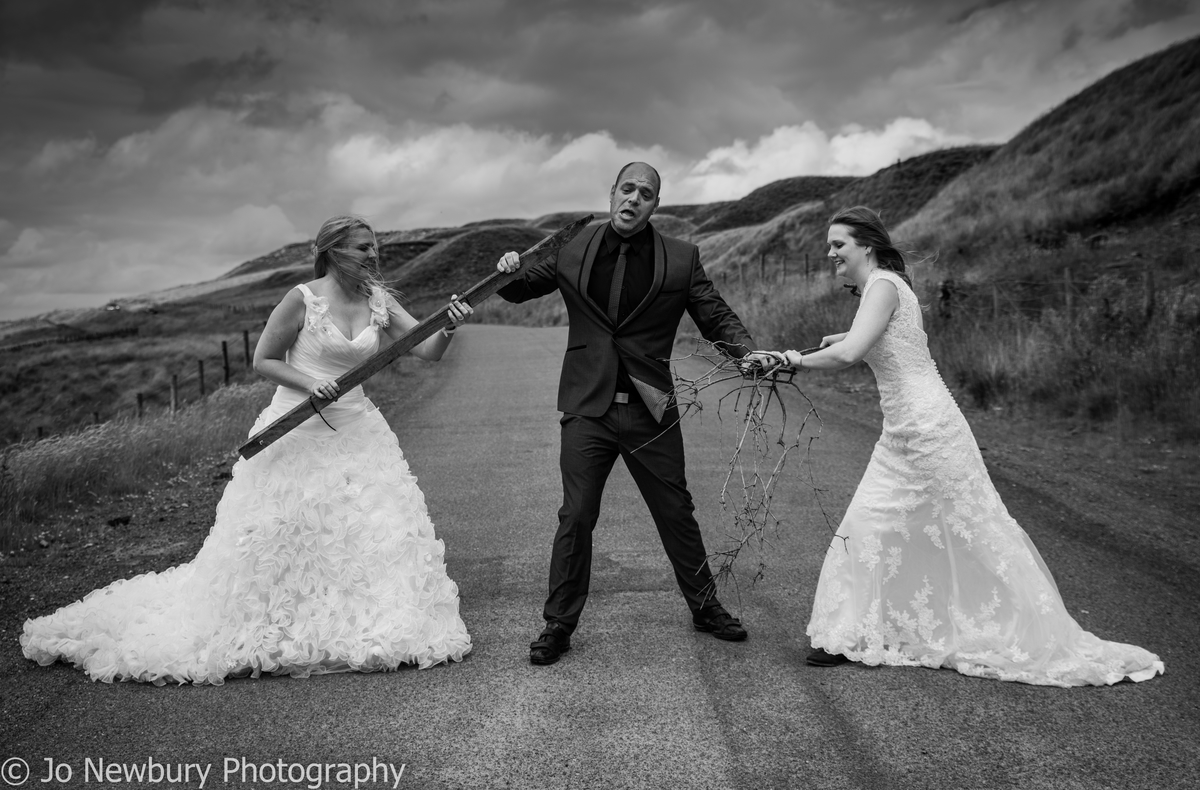 Jo Newbury Photography wedding brides fighting over groom fun shot