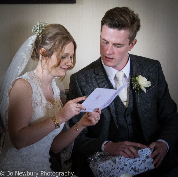 Jo Newbury Photography wedding image bride and groom opening cards.